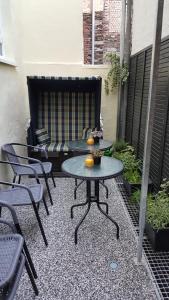 a patio with a table and chairs and a bench at Ferienhaus BARFLY in Traben-Trarbach