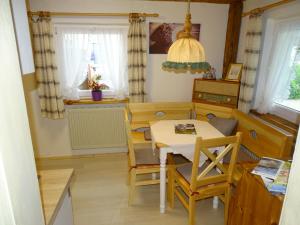a small dining room with a table and chairs at Ferienhäuschen in Inzell