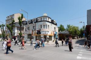 a group of people crossing a street in a city at Golden House in Varna City