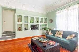 a living room with a blue couch and a table at Casa Professa Luxury Palermo Center in Palermo