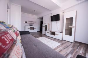 a living room with a couch and a tv at Labirint Apartament in Constanţa