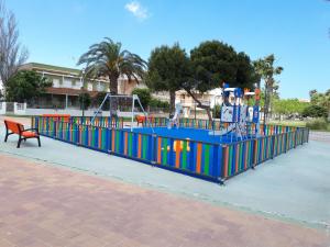 a playground in a park with a bench at Sheron's Apartment in Los Alcázares