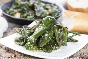 a plate of green vegetables on a table at A Casa das Burgas in Cuntis
