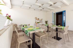 a dining room with tables and chairs in a room at Affittacamere Sirius in San Vito lo Capo