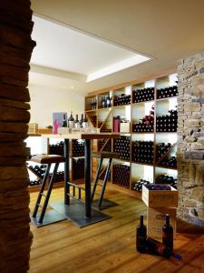 a wine cellar with a table and a wall of wine bottles at Hotel Alpenfriede in Sölden