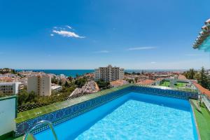 a swimming pool on the roof of a building with a view at Verano Azul 61B Nerja in Nerja