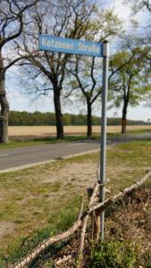 a blue street sign on the side of a road at Natur-Freude-19p in Kotzen