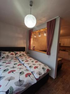 ein Schlafzimmer mit einem Bett mit einer bunten Bettdecke in der Unterkunft Apartma F&M in Bovec