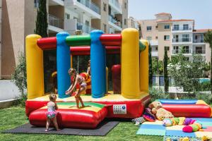 a woman and a child playing on a inflatable playground at Elysia Park in Paphos