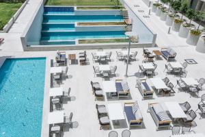 an overhead view of a pool with chairs and tables at Elysia Park in Paphos