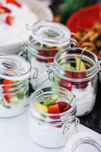 a group of jars filled with fruit and yogurt at Elysia Park in Paphos
