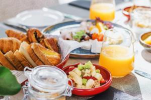a table with a plate of food and a bowl of bread at Elysia Park in Paphos