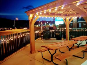 a wooden picnic table under a gazebo with lights at Great Western Colorado Lodge in Salida
