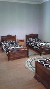 a room with three beds in a room at Toma's vila in Borjomi