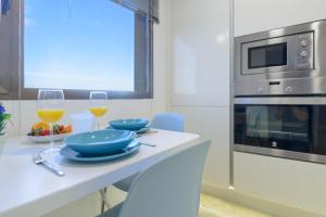 a kitchen with a table with two glasses of wine at Villa Marina, Sol y Sal in Las Palmas de Gran Canaria
