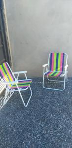 two lawn chairs sitting next to each other at Casa Nova Ótima Escolha in Bonito