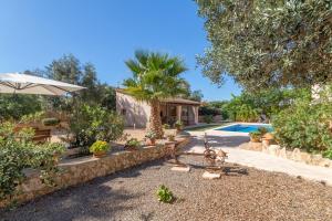 a villa with a swimming pool and a yard at Portocolom - 2618-36 Mallorca in Portocolom