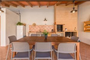 a kitchen with a large wooden table and chairs at Portocolom - 2618-36 Mallorca in Portocolom