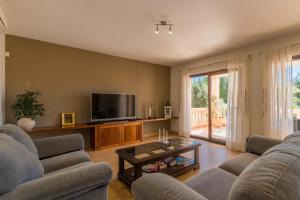 a living room with two couches and a tv at Portocolom - 2618-36 Mallorca in Portocolom