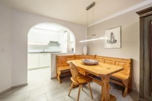 a kitchen and dining room with a wooden table and chairs at LAAX Homes - Runca 752 in Flims
