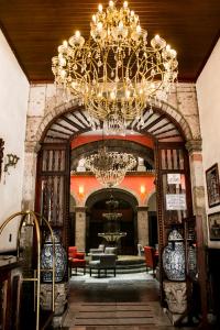 a large lobby with a chandelier in a building at Hotel Frances in Guadalajara