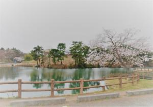 a fence next to a lake with a tree at Hotel Ocean Iwasawa / Vacation STAY 33555 in Kido