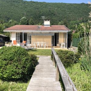 a house with a wooden walkway in front of it at Angel Services - LA MAISON DE LA PLAGE in Sévrier