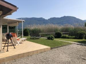 a camera on a tripod next to a house with mountains at Angel Services - LA MAISON DE LA PLAGE in Sévrier +12 photos
