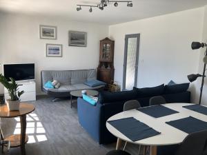 a living room with a couch and a table at Angel Services - LA MAISON DE LA PLAGE in Sévrier