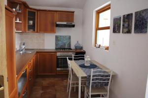 a small kitchen with a table and chairs in it at Apartment Lilly in Nerezine