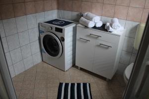 a washer and dryer in a bathroom at Apartment Lilly in Nerezine