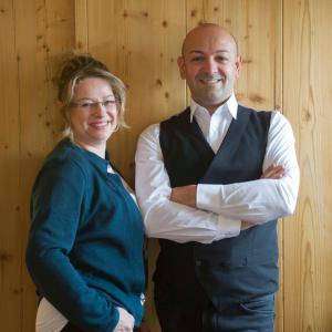 a man and a woman standing with their arms crossed at Rossano Boutique Hotel & Ristorante in Ansbach