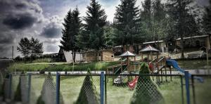 a park with a playground with a slide at domek campingowy in Brachlewo