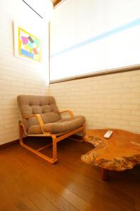 a chair and a coffee table in a room at Takayama - Apartment / Vacation STAY 34379 in Takayama