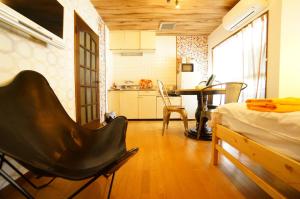 a room with a bed and a kitchen with a table at Takayama - Apartment / Vacation STAY 34381 in Takayama