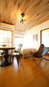 a bedroom with a bed and a table and chairs at Takayama - Apartment / Vacation STAY 34381 in Takayama