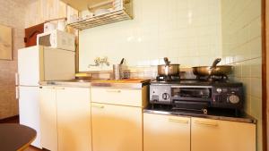 Il comprend une cuisine équipée d'une cuisinière et d'un réfrigérateur. dans l'établissement Takayama - Apartment / Vacation STAY 34382, à Takayama