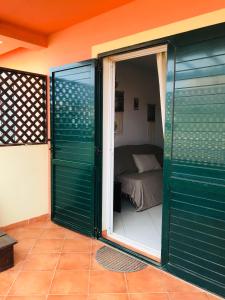 a room with a sliding glass door with a bed at Blue Ocean in Santa Maria