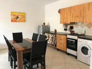 a kitchen with a table and chairs and a stove at Blue Ocean in Santa Maria +17 photos