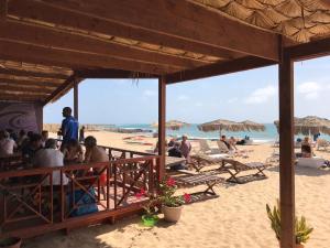 a group of people sitting on the beach at Blue Ocean in Santa Maria