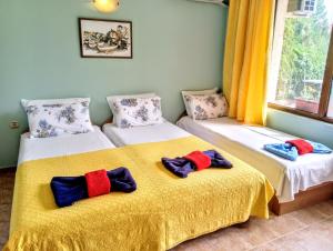 a room with two beds with towels on them at Guest House Maria in Nesebar