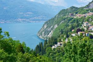 a view of a town on a hill with a body of water at Hotel Diffuso Il Portichetto sulla collina a Vezio Perledo in Perledo