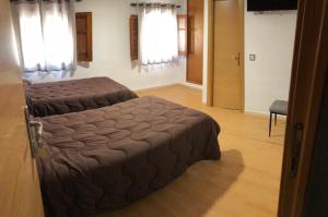 a bedroom with a large bed in a room at Hostal El Arco in Almazán