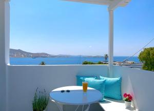 a table on a balcony with a view of the ocean at Central Suites Mykonos in Mýkonos City