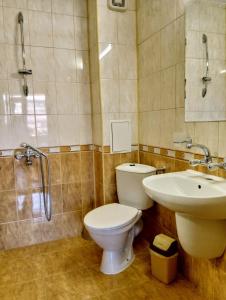 a bathroom with a toilet and a sink and a shower at Guest House Maria in Nesebar +39 photos