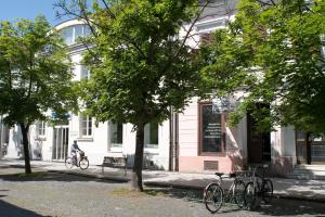 a person riding a bike in front of a building at Millennium apartments in Čakovec