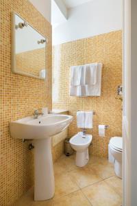 マルサラにあるMia Apartmentsのバスルーム(洗面台、トイレ、鏡付)