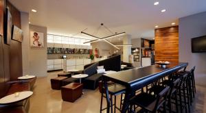 a restaurant with a bar and some tables and chairs at NU Hotel in Brooklyn