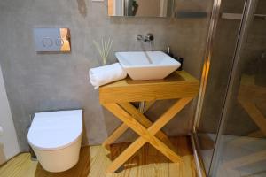 a bathroom with a sink and a toilet at Casa Sulfato in Campo do Gerês
