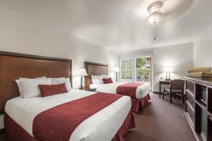 a hotel room with two beds and a television at Palm Mountain Resort & Spa in Palm Springs